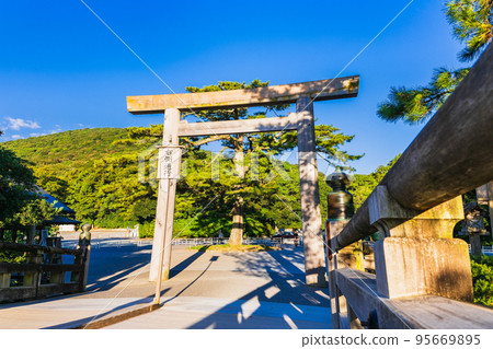 Ise Jingu Inner Shrine Uji Bridge Torii illuminated by the morning sun 95669895