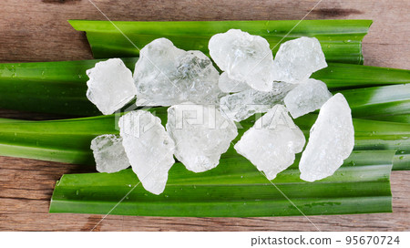 Crystal clear alum cubes or Potassium alum on green leaf Chemical compound substance Concept for beauty spa and underarm treatment industrial                       95670724