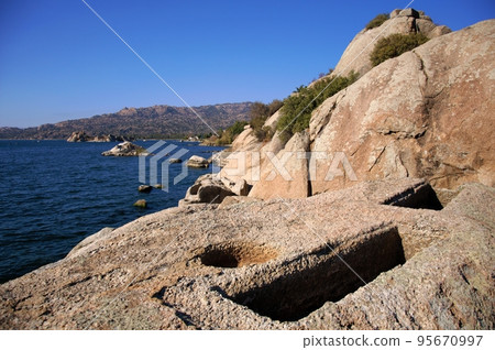 Landscape around Lake Bafa in Turkey, with ancient tombs near the water. Landscape around Lake Bafa in Turkey, with ancient tombs near the water. 95670997