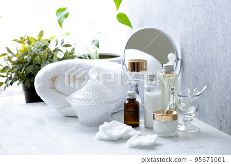 Image of morning skin care with various types of cosmetic bottles lined up on the windowsill 95671001