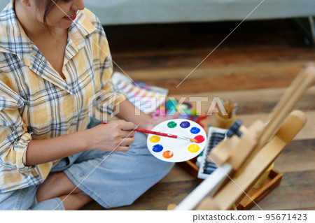 Portrait of an Asian woman designing art in her spare time Portrait of an Asian woman designing art in her spare time 95671423