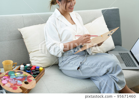 Portrait of an Asian woman designing art in her spare time Portrait of an Asian woman designing art in her spare time 95671460