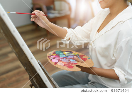 Portrait of an Asian woman designing art in her spare time Portrait of an Asian woman designing art in her spare time 95671494