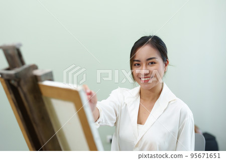 Portrait of an Asian woman designing art in her spare time Portrait of an Asian woman designing art in her spare time 95671651
