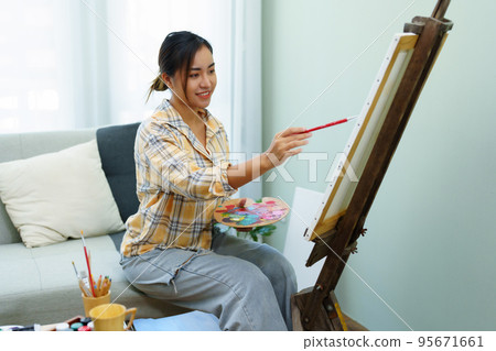 Portrait of an Asian woman designing art in her spare time Portrait of an Asian woman designing art in her spare time 95671661