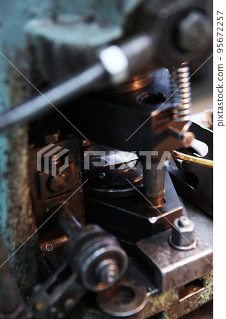 Elements of an old machine for the production of bearings or other parts. Metal parts. Old technology. Heavy industry. Selective focus. 95672257