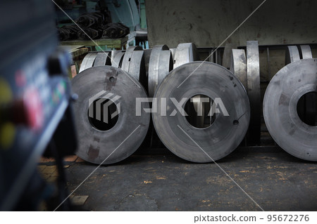 Blanks for large diameter bearings. Metal products. Heavy industry.The control panel with the red button on the production is out of focus.The concept of the industrial industry. Blanks for large diameter bearings. Metal products. Heavy industry.The control panel with the red button on the production is out of focus.The concept of the industrial industry. 95672276