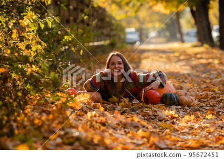 Portrait of happy smile woman with pumpkins in hand. 95672451