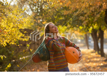 Portrait of happy smile woman with pumpkins in hand. Portrait of happy smile woman with pumpkins in hand. 95672457