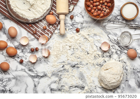 Close-up shot. Top view of a baking ingredients and kitchenware on the marble table background. 95673020