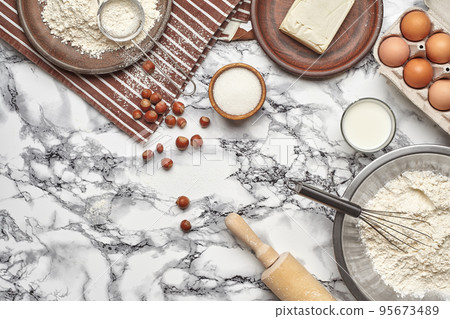 Close-up shot. Top view of a baking ingredients and kitchenware on the marble table background. 95673489