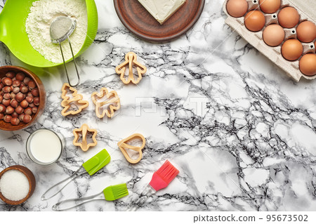 Close-up shot. Top view of a baking ingredients and kitchenware on the marble table background. Close-up shot. Top view of a baking ingredients and kitchenware on the marble table background. 95673502