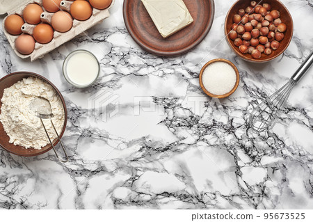 Close-up shot. Top view of a baking ingredients and kitchenware on the marble table background. 95673525