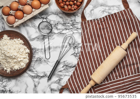 Close-up shot. Top view of a baking ingredients and kitchenware on the marble table background. 95673535