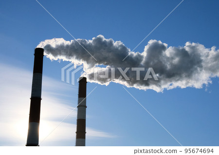 Cityscape with pipes of thermal power plant, against a blue sky background. Ecology problems. Pollution. Cityscape with pipes of thermal power plant, against a blue sky background. Ecology problems. Pollution. 95674694