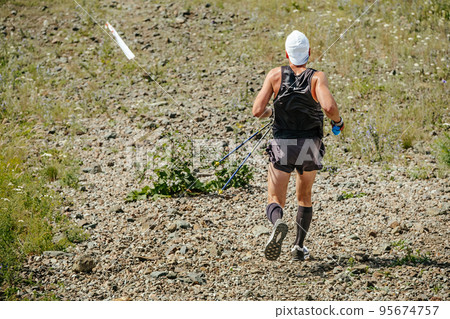 back man athlete with hiking poles running back man athlete with hiking poles running 95674757