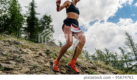 female runner running down mountain trail female runner running down mountain trail 95674761
