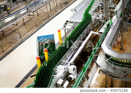 Beer factory bottles on the line. Technological line for washing of glass bottles for beer. High Beer factory bottles on the line. Technological line for washing of glass bottles for beer. High 95675286
