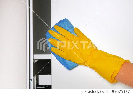 Household chores. Hand using a rag is cleaning furniture at home. Maid cleans house.  95675327