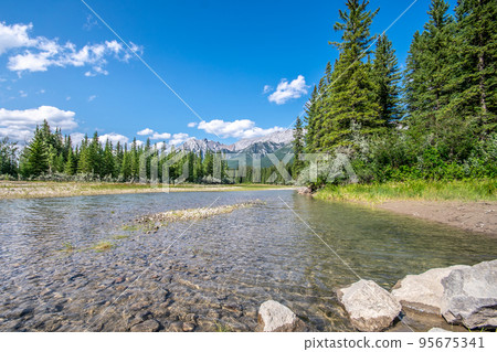 A beautiful photo of river in Canmore, Alberta with the rocky mountains in the background.  95675341