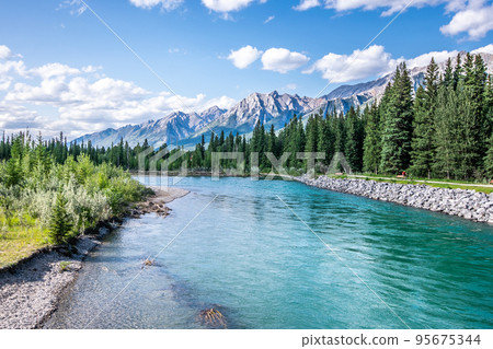 A beautiful photo of river in Canmore, Alberta with the rocky mountains in the background.  95675344