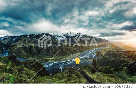 Scenery of hiker standing on top of Valahnukur viewpoint among the mountain and river in Icelandic Highlands 95675383