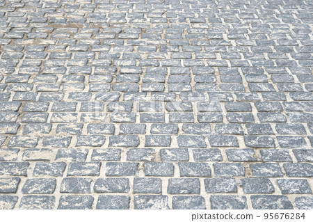 Gray Paving stone, background. Pedestrian zone in the park in daylight. Urban walkway. 95676284