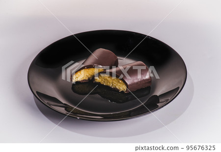 A piece of chocolate cake with mint on the table, close-up 95676325