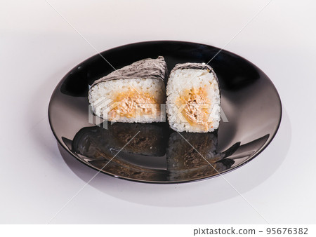 Onigiri or Japanese seaweed rice triangles shaped Stuffed with grilled eel, scallop, plum and fish roe, Japanese Rice Balls famous food. Onigiri or Japanese seaweed rice triangles shaped Stuffed with grilled eel, scallop, plum and fish roe, Japanese Rice Balls famous food. 95676382