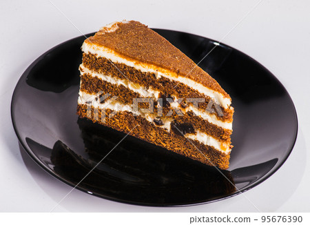 carrot cake with walnuts, prunes and dried apricots on a dark wood background. tinting. selective focus 95676390