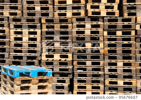 Pallets background. Stacks of old rough wooden pallets at warehouse in industrial yard. Cargo and shipping concept. Pallets background. Stacks of old rough wooden pallets at warehouse in industrial yard. Cargo and shipping concept. 95676687