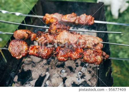 meat on charcoal shish kebab grill, close view 95677409