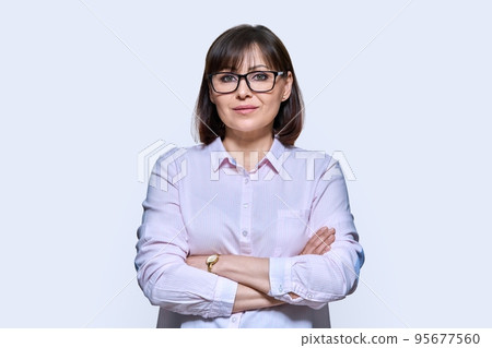 Portrait of confident middle-aged business woman on light background 95677560