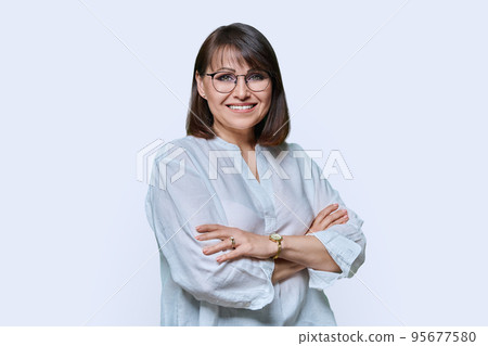 Positive middle aged woman looking at camera on white studio background 95677580
