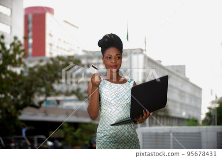 Businesswoman doing online shopping through laptop and credit card Businesswoman doing online shopping through laptop and credit card 95678431