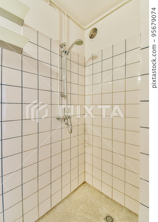 Sink and mirror located near flush toilet and shower 95679074