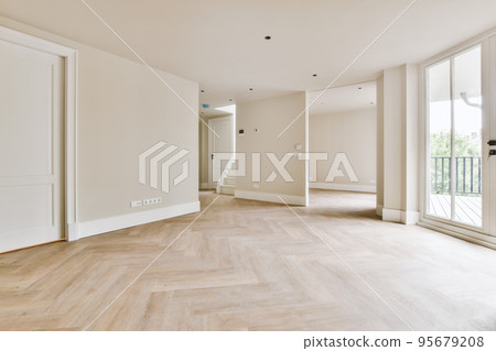 Interior of empty white kitchen with windows and wooden parquet floor Interior of empty white kitchen with windows and wooden parquet floor 95679208