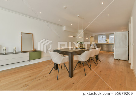 Couches and table located near dining area of spacious room in contemporary apartment Couches and table located near dining area of spacious room in contemporary apartment 95679209