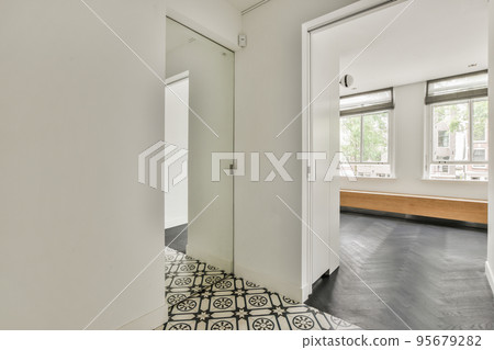 Light hallway with glass door in white walls 95679282
