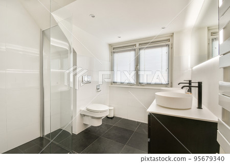Interior of contemporary bathroom with shabby beige walls and partitions and white door at home 95679340