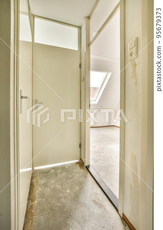 Perspective view of empty narrow hallway with white walls and parquet floor in minimalist style apartment Perspective view of empty narrow hallway with white walls and parquet floor in minimalist style apartment 95679373