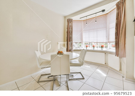 Interior of light kitchen and dining room with at daytime 95679523