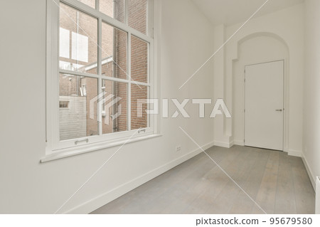 Plastic window and radiator on white wall in empty light room at home Plastic window and radiator on white wall in empty light room at home 95679580