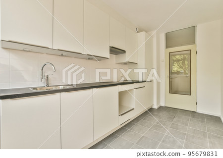 Interior of empty white kitchen with windows 95679831