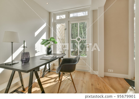 Couches and table located near dining area of spacious room in contemporary apartment 95679901
