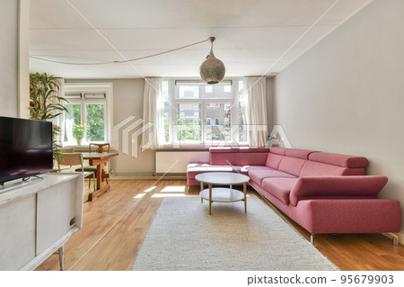 Interior of modern room illuminated with sunlight from ceiling window and door in modern house Interior of modern room illuminated with sunlight from ceiling window and door in modern house 95679903
