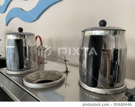 Shiny metal chrome teapots for brewing hot tasty tea 95680446