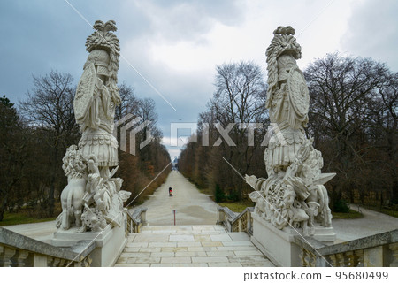 View on alley in the park at Schonbrunn in Vienna - person with child in stroller View on alley in the park at Schonbrunn in Vienna - person with child in stroller 95680499