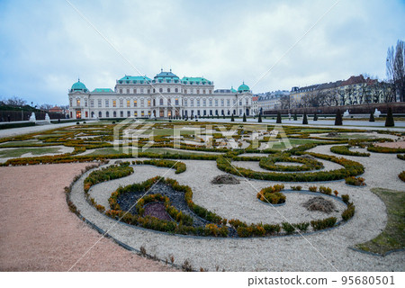 View of the alley in the Schoenbrunn park in Vienna - Palace and citycap[e and Church Saint Otmar among the white tanners View of the alley in the Schoenbrunn park in Vienna - Palace and citycap[e and Church Saint Otmar among the white tanners 95680501