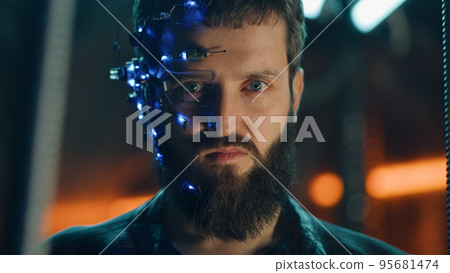Young bearded guy in black leather jacket looks fiercely at the camera Cyberpunk Young bearded guy in black leather jacket looks fiercely at the camera Cyberpunk 95681474